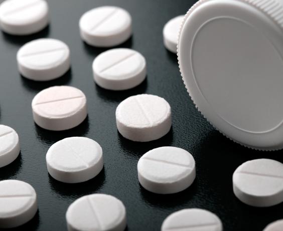 Pills next to a bottle.