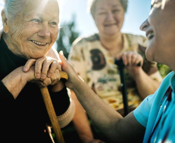 Health care provider smiling with a senior woman.