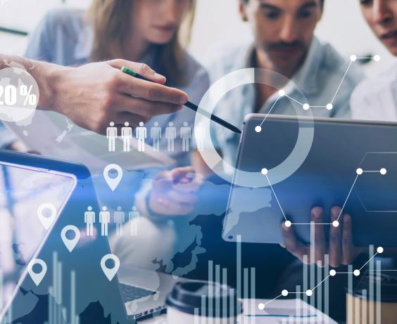 People collaborating with digital charts and data graphics overlaid on the image.